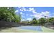 Well-maintained community tennis court surrounded by lush trees offers a recreational amenity for residents at 3330 Overland Dr, Roswell, GA 30075