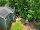 View of the backyard with a playset, patio with outdoor seating, and lush greenery at 530 Camber Woods Dr, Roswell, GA 30076