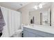 Bathroom featuring a vanity, toilet, mirror, and tub with shower and a patterned curtain at 530 Camber Woods Dr, Roswell, GA 30076