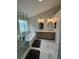Bathroom with a soaking tub, glass shower, double vanity, and modern tile flooring at 530 Camber Woods Dr, Roswell, GA 30076