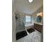 Bathroom featuring a glass shower, soaking tub, vanity, and marble tile flooring at 530 Camber Woods Dr, Roswell, GA 30076