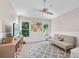 Neutral bedroom with a vaulted ceiling, ceiling fan, large windows and comfortable seating area at 530 Camber Woods Dr, Roswell, GA 30076