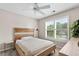 Bedroom with a modern bed, bright window, and light, neutral tones at 530 Camber Woods Dr, Roswell, GA 30076