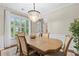 Bright dining room with a chandelier, large window, and a dining table for six at 530 Camber Woods Dr, Roswell, GA 30076