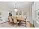 Elegant dining room featuring a chandelier, large window, and a dining table for six at 530 Camber Woods Dr, Roswell, GA 30076