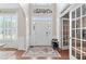 Bright foyer with hardwood floors, white wainscoting, decorative rug, and lots of natural light at 530 Camber Woods Dr, Roswell, GA 30076
