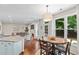 Well-lit kitchen flows to living room and nook, offering stainless appliances, generous counterspace, and open floor plan at 530 Camber Woods Dr, Roswell, GA 30076