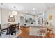 Bright eat-in kitchen with stainless steel appliances, granite countertops, wooden floors, and breakfast bar seating at 530 Camber Woods Dr, Roswell, GA 30076