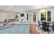 Well-lit kitchen flows to living room and nook, offering stainless appliances, generous counterspace, and open floor plan at 530 Camber Woods Dr, Roswell, GA 30076