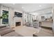 Open-concept living area features a fireplace, modern furnishings, and seamless transition to dining and kitchen spaces at 530 Camber Woods Dr, Roswell, GA 30076