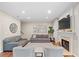 Inviting living room with fireplace, gray sofas, and neutral tones, creating a comfortable space for relaxation and gatherings at 530 Camber Woods Dr, Roswell, GA 30076