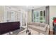 Well-lit home office with a comfortable sofa, a large window, and french doors at 530 Camber Woods Dr, Roswell, GA 30076