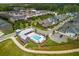 Aerial view of a community featuring a pool, clubhouse, green spaces and tree-lined streets at 6895 Whitman Walk, Alpharetta, GA 30005