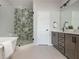 Luxurious bathroom featuring dual sinks, a glass-enclosed shower, and a soaking tub for a spa-like experience at 6895 Whitman Walk, Alpharetta, GA 30005