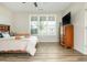 Bright, spacious bedroom with hardwood floors, large window, and a wooden dresser at 6895 Whitman Walk, Alpharetta, GA 30005