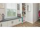 Organized closet features custom shelving, a window seat, and plenty of storage for shoes and accessories at 6895 Whitman Walk, Alpharetta, GA 30005