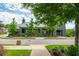 Charming clubhouse exterior with manicured landscaping and ample windows creating an inviting community gathering space at 6895 Whitman Walk, Alpharetta, GA 30005