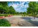 Inviting common area with picnic tables, string lights, and artificial turf providing a perfect spot for community gatherings at 6895 Whitman Walk, Alpharetta, GA 30005