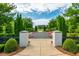 Beautifully landscaped common area with gravel pathways and vibrant pink seating creating a charming and inviting outdoor space at 6895 Whitman Walk, Alpharetta, GA 30005
