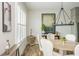 Bright dining area with natural light, a modern chandelier, and elegant furnishings at 6895 Whitman Walk, Alpharetta, GA 30005