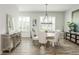 Dining room features modern chandelier and natural light at 6895 Whitman Walk, Alpharetta, GA 30005