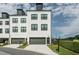 Contemporary townhome with painted brick, 1-car garage and manicured landscaping at 6895 Whitman Walk, Alpharetta, GA 30005