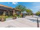 Outdoor dining area with covered seating, lush greenery, and a welcoming atmosphere on a sunny day at 6895 Whitman Walk, Alpharetta, GA 30005