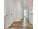 Long hallway with hardwood flooring and bright white walls at 6895 Whitman Walk, Alpharetta, GA 30005