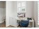 Bright office nook features a white desk, storage, a blue chair, and a window for a cozy workspace at 6895 Whitman Walk, Alpharetta, GA 30005