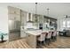 Modern kitchen boasts an island with seating, stainless appliances, and custom cabinets at 6895 Whitman Walk, Alpharetta, GA 30005