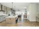 Open-concept kitchen features a spacious island, stainless steel appliances, and hardwood floors at 6895 Whitman Walk, Alpharetta, GA 30005