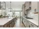 Bright kitchen featuring a large island, stainless steel appliances, and open dining area at 6895 Whitman Walk, Alpharetta, GA 30005