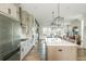 Spacious kitchen with a large island, stainless steel appliances, and an adjacent living area at 6895 Whitman Walk, Alpharetta, GA 30005