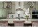 Close up of kitchen island with a modern faucet and pendant lighting, featuring quartz countertops at 6895 Whitman Walk, Alpharetta, GA 30005
