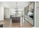 Modern kitchen with a center island, stainless steel appliances, and stylish lighting fixtures at 6895 Whitman Walk, Alpharetta, GA 30005