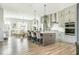Open-concept kitchen with stainless steel appliances, island with seating, and dining area at 6895 Whitman Walk, Alpharetta, GA 30005