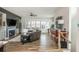 Comfortable living room with a fireplace, hardwood floors, and plenty of natural light at 6895 Whitman Walk, Alpharetta, GA 30005