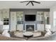 Living room features a cozy fireplace, television, and plenty of natural light at 6895 Whitman Walk, Alpharetta, GA 30005