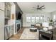 Open-concept living room with a fireplace, TV, and large windows at 6895 Whitman Walk, Alpharetta, GA 30005