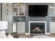 Living room includes fireplace, television, custom cabinetry, and a wet bar at 6895 Whitman Walk, Alpharetta, GA 30005