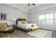 Spacious main bedroom features a large window, tray ceiling, and decorative seating area with a yellow bench and chairs at 6895 Whitman Walk, Alpharetta, GA 30005