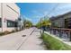 A well-maintained pedestrian street with outdoor seating, dining, and storefronts under a sunny sky at 6895 Whitman Walk, Alpharetta, GA 30005