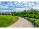 Scenic walking path winding through lush greenery, offering a peaceful outdoor experience for residents at 6895 Whitman Walk, Alpharetta, GA 30005