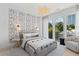Inviting bedroom with natural light, stylish wallpaper, and a comfortable seating area with city views at 775 Juniper St # 111, Atlanta, GA 30308