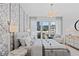 Bright bedroom with decorative wallpaper, natural light, and a comfortable chair near a view of the city at 775 Juniper St # 111, Atlanta, GA 30308
