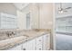 Bathroom with double sinks, granite counters, and neutral color palette at 1147 Saint Phillips Ct, Locust Grove, GA 30248