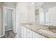 Bathroom featuring dual sinks, granite counters, walk-in shower, and white cabinets at 1147 Saint Phillips Ct, Locust Grove, GA 30248