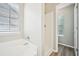 A bright bathroom featuring a tub and shower combo next to a window at 1147 Saint Phillips Ct, Locust Grove, GA 30248