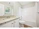 Bright bathroom features granite countertop, white vanity, and shower-tub combo at 1147 Saint Phillips Ct, Locust Grove, GA 30248