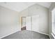 Bright bedroom features neutral walls, plush carpet, and access to closet and additional room at 1147 Saint Phillips Ct, Locust Grove, GA 30248